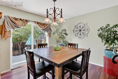 Dining room featuring wood finished floors and a chandelier