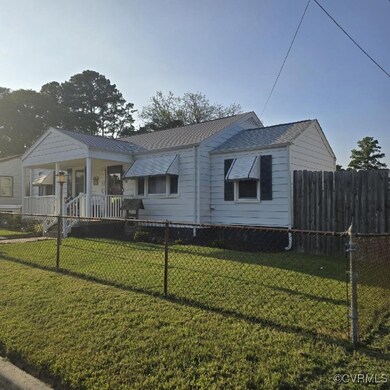 View of front of home with a front lawn and a porc