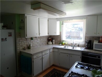 Kitchen. Kitchen has pleasant view of large yard.
