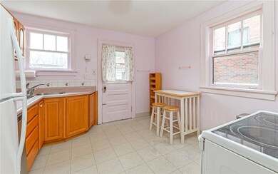 Fully equipped eat in kitchen with door that leads