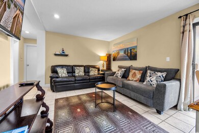 Living area with light tile patterned floors and recessed lighting