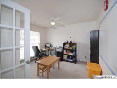 FROM THE FOYER DOUBLE FRENCH DOOR LEAD TO THE FORMAL LIVING ROOM OR STUDY WITH CARPET AND CEILING FAN