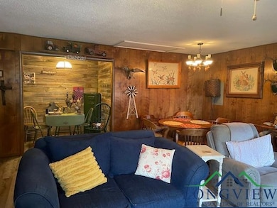 Living area with a textured ceiling and a chandeli