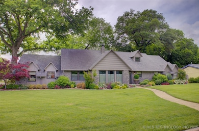 Mid-century modern home with a front lawn, a shing