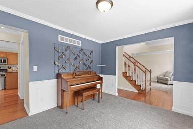 Central staircase and dining room right off the en
