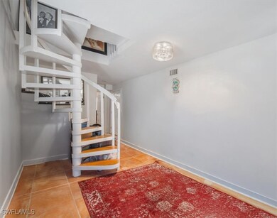 Stairs with baseboards and tile patterned floors