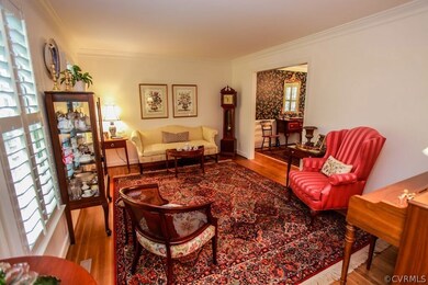 Living room with wood floors, plantation shutters,