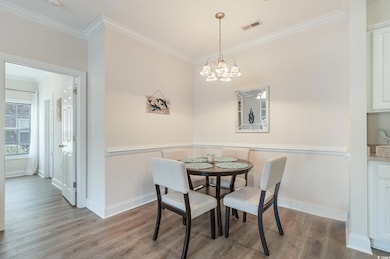 Dining room featuring crown molding, visible vents