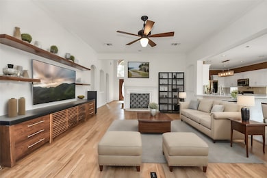 Relax in the expansive living room,
highlighted by a custom media unit
and sleek hardwood floors. The
room flows effortlessly into the
dining and kitchen areas, creating
a cohesive space for family
gatherings and entertaining
guests.