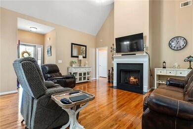 Living area featuring high vaulted ceiling, basebo