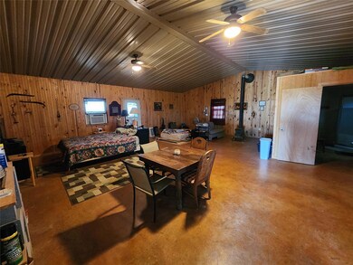 Dining room with lofted ceiling, concrete flooring