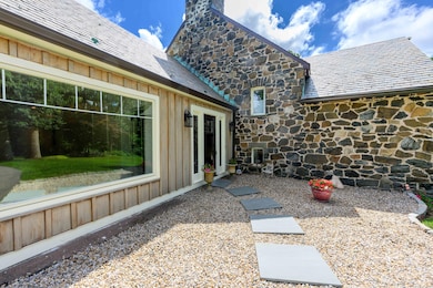 New bluestone and pea stone walkway, new entry door, new cedar cladding, new bay window!