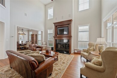 Living area featuring a high ceiling, a chandelier