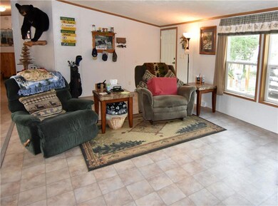 The living room features large windows to let in n