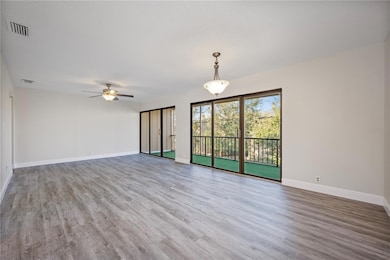 The covered front entry opens up to your light and bright great room with space for both living and dining and two sets of TRIPLE SLIDING GLASS DOORS for endless NATURAL LIGHT and access to a spacious screened outdoor space.