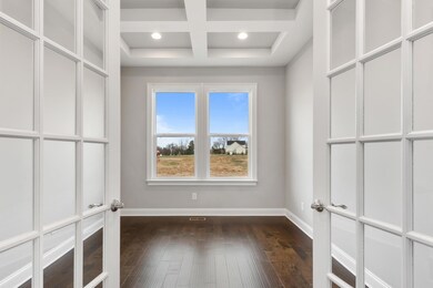 Private Study with coffered ceiling, french doors, and lots of natural light!