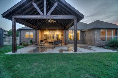 Rear view of property featuring a patio area, fenc