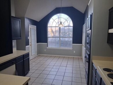Kitchen featuring white appliances, light tile pat