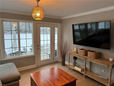 Family room with  single French door leading to Un