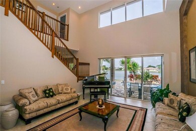 Formal living area overlooking patio and lake