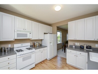 Kitchen has refinished hardwood floors.