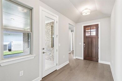 Foyer entrance with wood finished floors and base