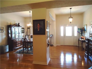 This view of the formal dining room and foyer reflect the open floor plan of this immaculate home.