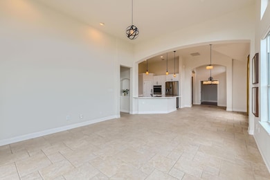 Unfurnished living room featuring a sink, arched 