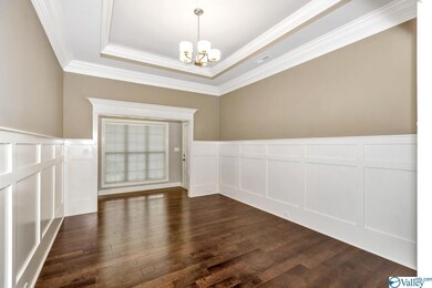 Enjoy meals and gatherings here with beauty surrounding you from the hardwood floors to the crown molding, chair rail and wainscoting