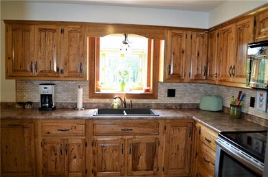Rustic Hickory cabinets and garden window for lots