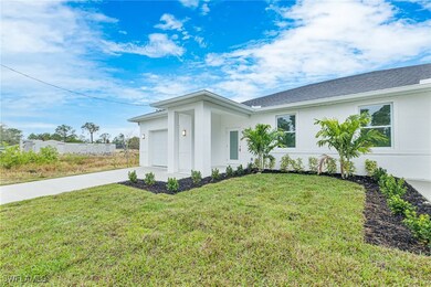View of side of home featuring a lawn, stucco sidi