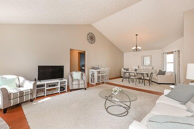 Great room & Dining room featuring vaulted ceiling