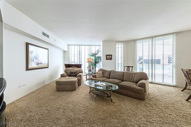 Carpeted living area featuring plenty of natural l
