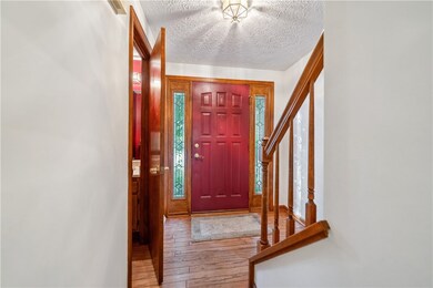 Front entry and view of first floor half bathroom