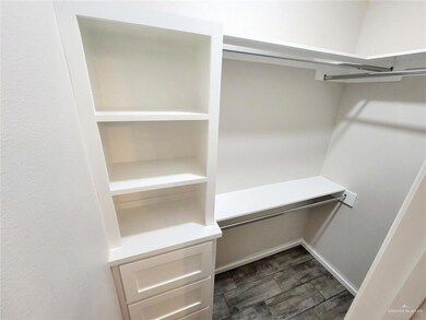 Spacious closet with dark wood-type flooring