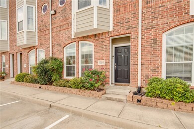Doorway to property with uncovered parking and bri