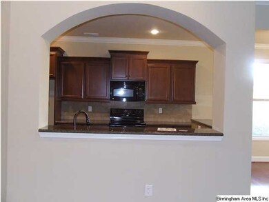 Granite serving bar between the family room and ki