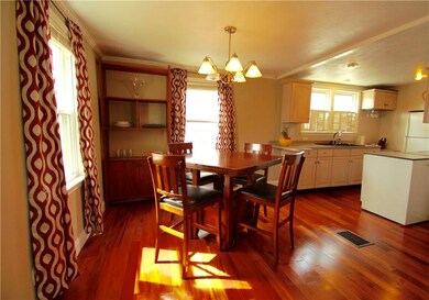 Newer tiger wood floors gleam in the kitchen and d