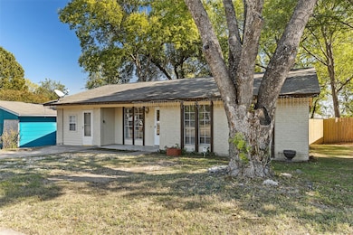 Ranch-style house with brick siding, roof with sh
