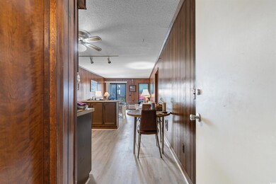 Corridor featuring light wood-style floors, wood w