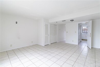 Empty room with light tile patterned flooring, baseboards, and visible vents