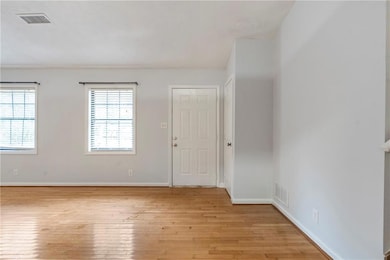 Empty room featuring baseboards and light wood finished floors