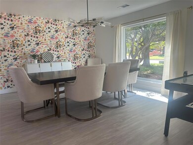 Dining area with wallpapered walls, wood finished 