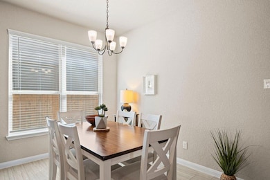 Dining area with a textured wall, light wood fini