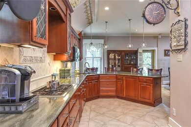 Gorgeous gourmet kitchen with cherry cabinets, gra