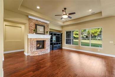 Spacious living room featuring a fireplace and cus