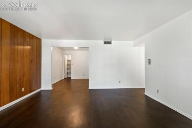 Living room splits to bedrooms and dining area