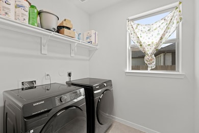 Expansive laundry room features large tile floorin