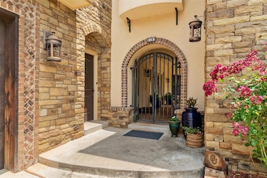 Property entrance with stone siding, brick siding, and a gate