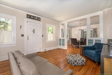 Spacious living room with custom built-ins, hardwo